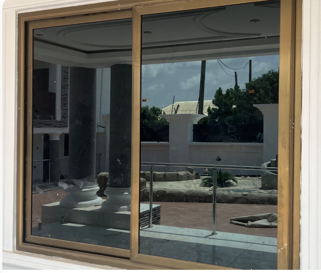 Wide Golden Frame Tinted Sliding Glass Window